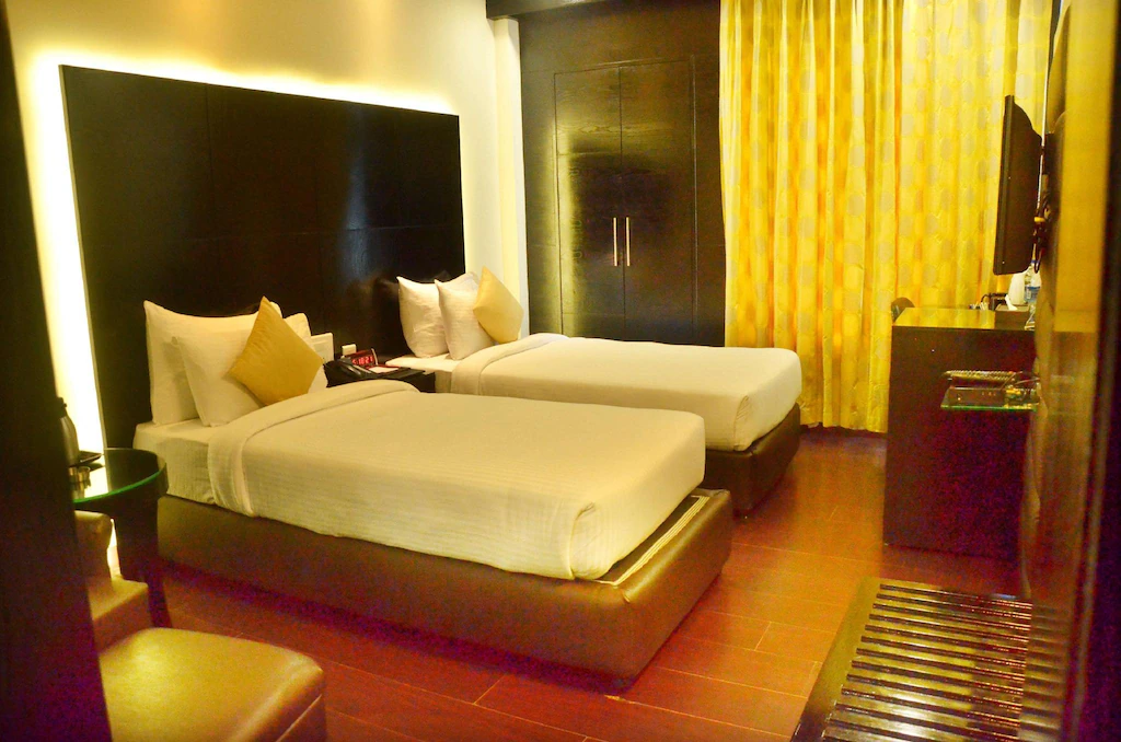 Deluxe room at Best Western Bliss, Kanpur showing added space, seating area, and clean modern furnishings