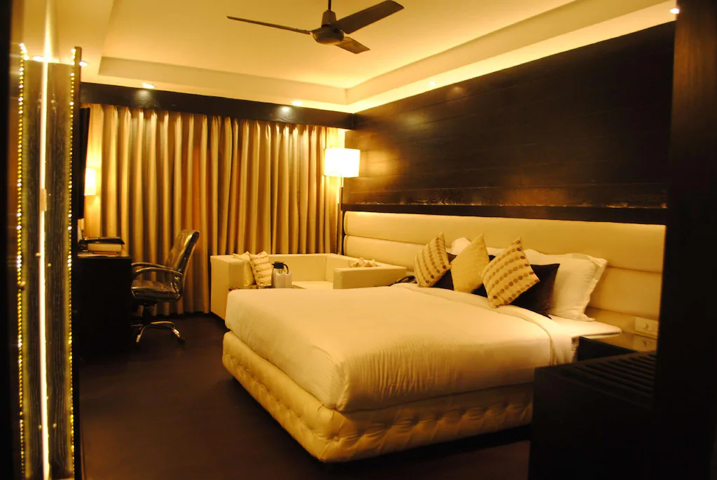 Standard room at Best Western Bliss, Kanpur with neatly arranged bed, side tables, and simple interior design