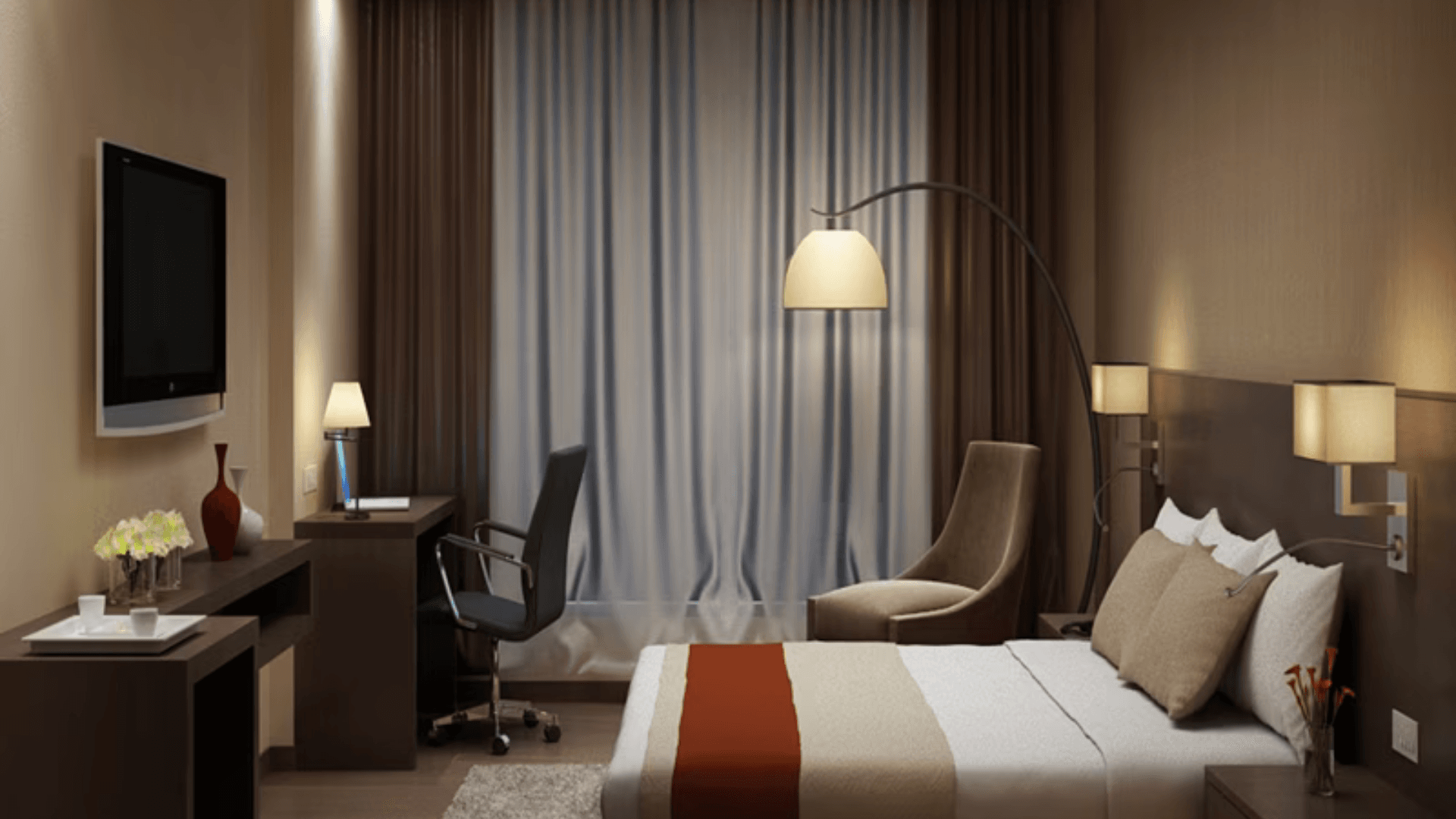 Deluxe room at Heaven View Clarks Inn, Kanpur with added seating space and warm interior lighting