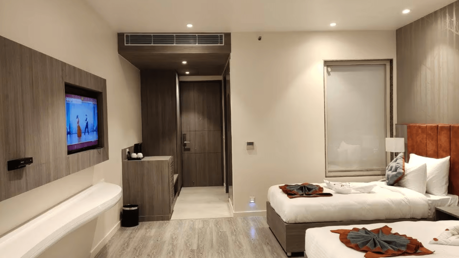 Deluxe room at Deep Clarks Inn Lucknow with added space, seating area, and warm interior lighting