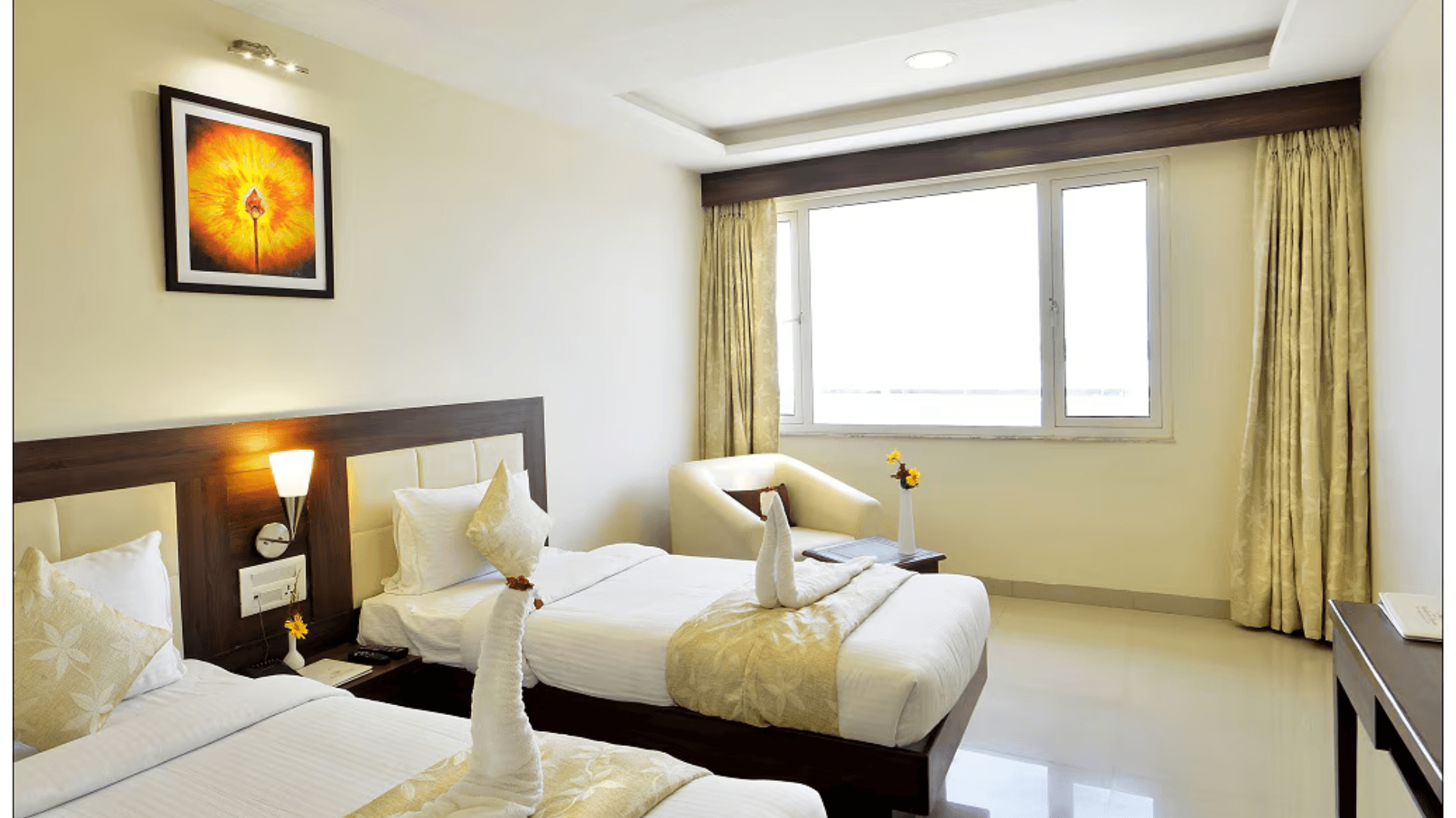 Hotel Madhuram Royale Jodhpur opens with a location-first focus, placing you within convenient reach of the city’s transport corridors, marketplaces, and cultural highlights. This strategic positioning makes it an excellent choice for travelers who want to maximize their time in Jodhpur without losing comfort. Rooms at Hotel Madhuram Royale Jodhpur are designed with usability in mind, offering a calm retreat after busy days of sightseeing or business meetings. The Deluxe Room and Super Deluxe Room categories are welcoming spaces with thoughtful layouts, soft lighting, and restful interiors that support both relaxation and light productivity. These room environments help guests recharge whether their trip is leisure-driven or work-oriented. Dining is anchored on property with a well-managed restaurant that streamlines meals into your itinerary rather than forcing external planning. Guests can enjoy familiar favourites and local flavours in a relaxed setting before heading out again. The swimming pool becomes a refreshing stop for those seeking a break from city exploration or outdoor engagements, especially during warmer afternoons. For travelers seeking an accessible base with practical comforts and uncomplicated service, Hotel Madhuram Royale Jodhpur delivers. Secure your accommodation via AtulyaHotels.com and enjoy a well-positioned Jodhpur stay crafted around ease and everyday convenience.