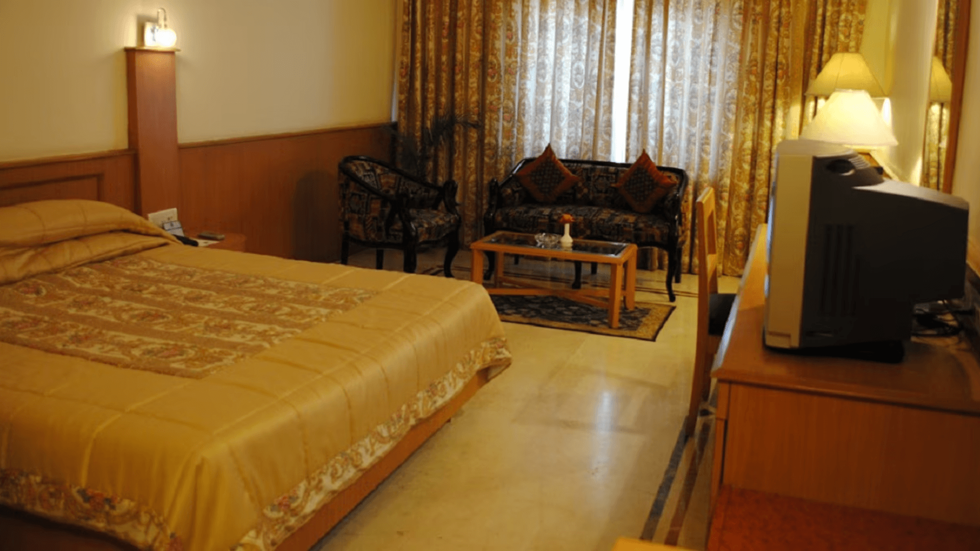 Deluxe room at Empires Hotel, Paradeep featuring spacious layout and work desk