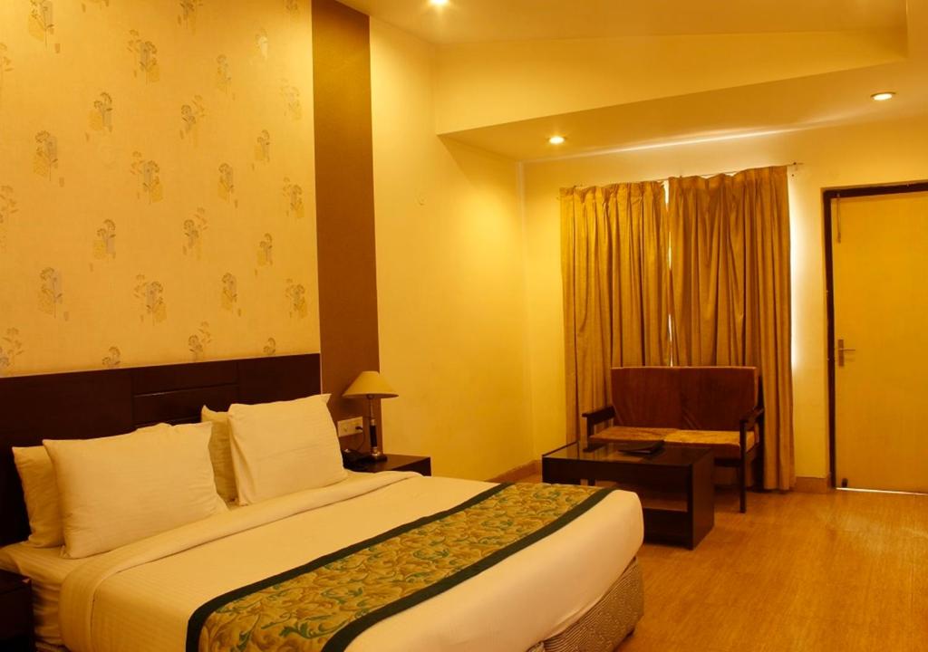 Deluxe room at MB Greens Clarks Inn Moradabad with added space and seating arrangement