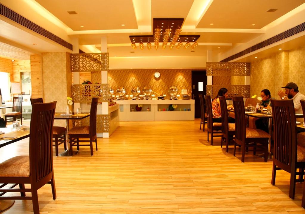 Restaurant at MB Greens Clarks Inn Moradabad displaying dining tables and interior arrangement