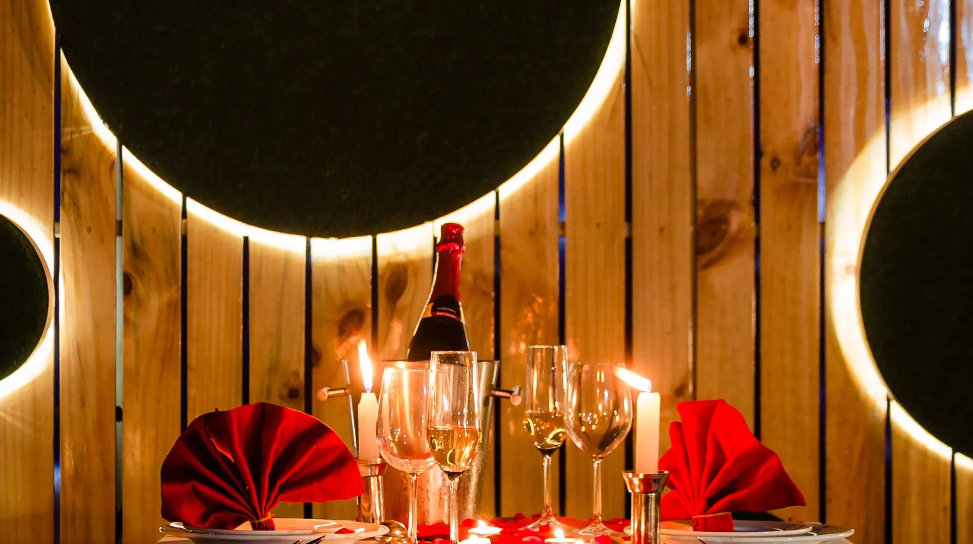 a table with wine glasses and candles