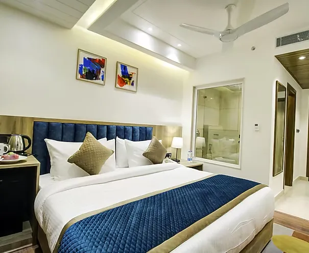 Superior room at Cygnett Style Ganga Jaipur featuring bed, side tables, and window light