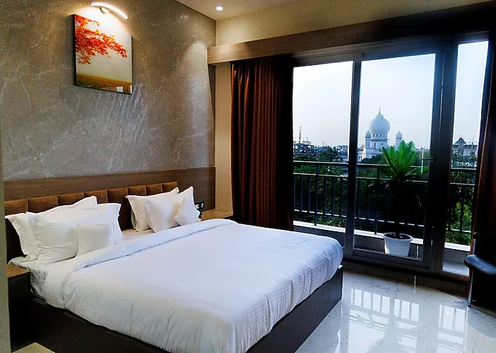 Premium balcony room at Hotel Aryavilas Mathura featuring elegant décor and premium bedding arrangement