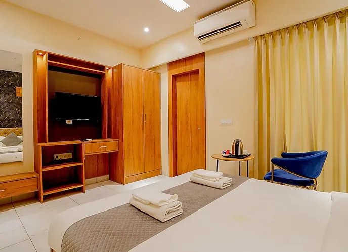 Deluxe room at Hotel Ekana Jagatpura Jaipur with spacious floor area and seating arrangement
