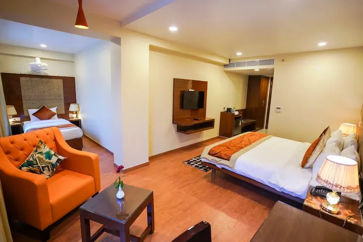 Suite room at Hotel Indo Prime Jaipur with extended space and seating area