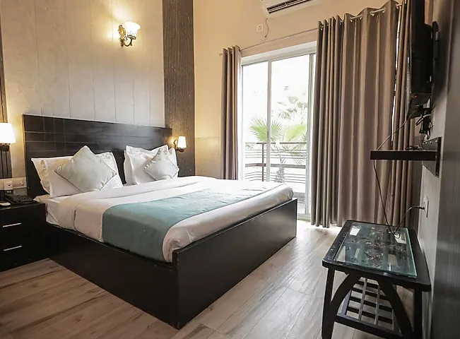Deluxe room at NANDAN RETREAT Vrindavan with added space, seating area, and natural light