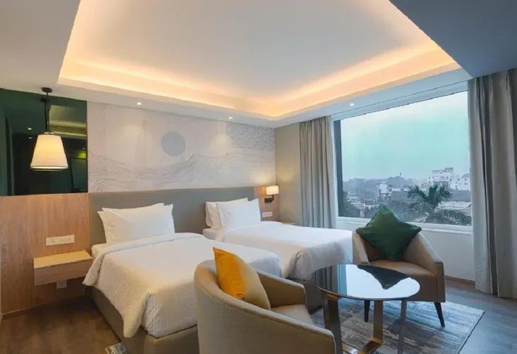 Deluxe room at Park Inn by Radisson Ayodhya featuring larger space, seating area, and window view