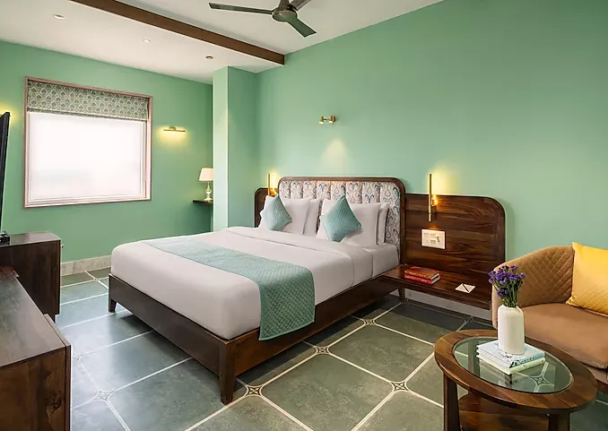 Designer Premium room at Raasvan Vrindavan AM Hotel Kollection Vrindavan showing enhanced interiors and seating space