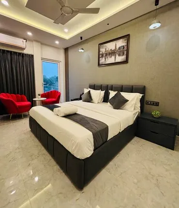 Super Deluxe room at RK Villa Near Prayagraj Airport Prayagraj showing extra space and seating area