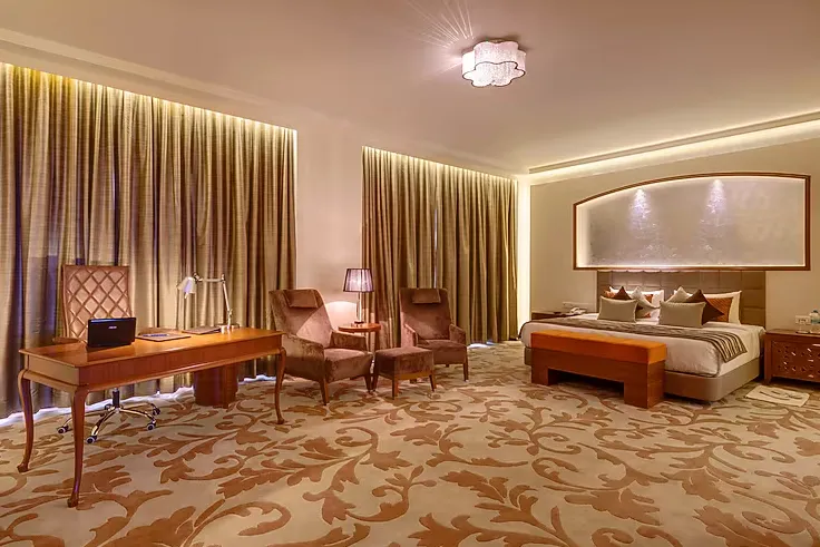Suite room at Balaji Sarovar Premiere Solapur featuring bed and sitting area
