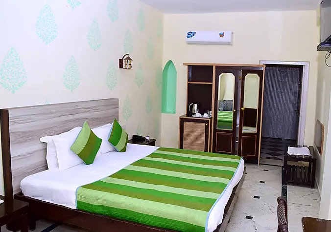 Deluxe room with bathtub at Himmatgarh Palace Jaisalmer showing tub and bedding