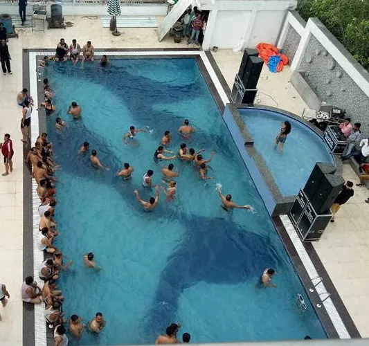 Swimming pool at Hotel Shiv Vilas Palace Bharatpur with deck seating