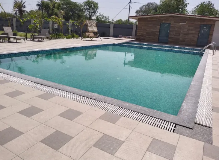 Outdoor swimming pool at Hotel The White Season Bhilwara with pool deck and seating
