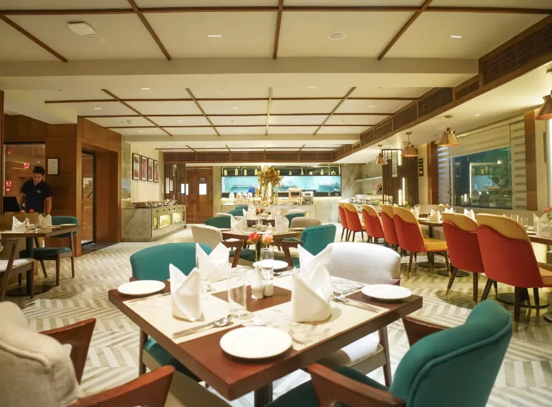 Restaurant at Ishaan Sarovar Portico Deoghar with dining tables and interior setup