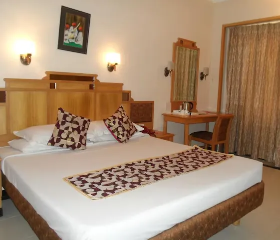 Family Suite Room at Kalyan Residency Tirupati with wide bed and seating space