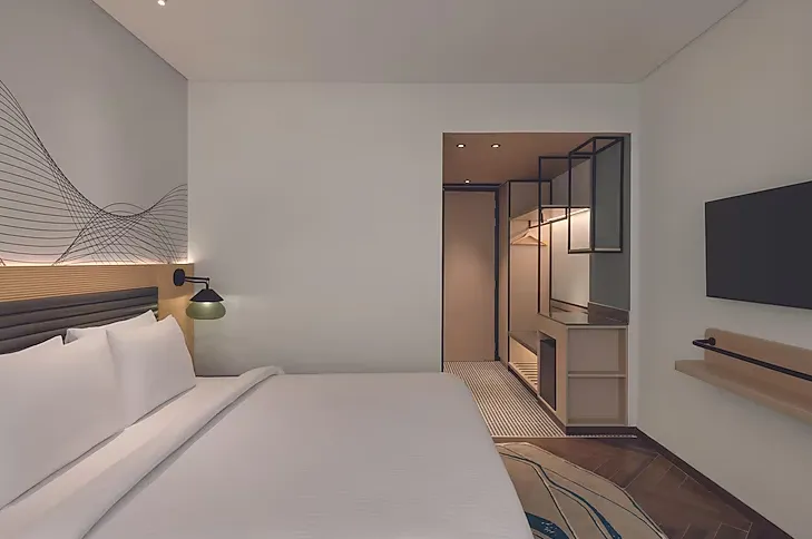 Deluxe room at Ramada Encore By Wyndham Bhiwadi featuring king bed and clean interior design