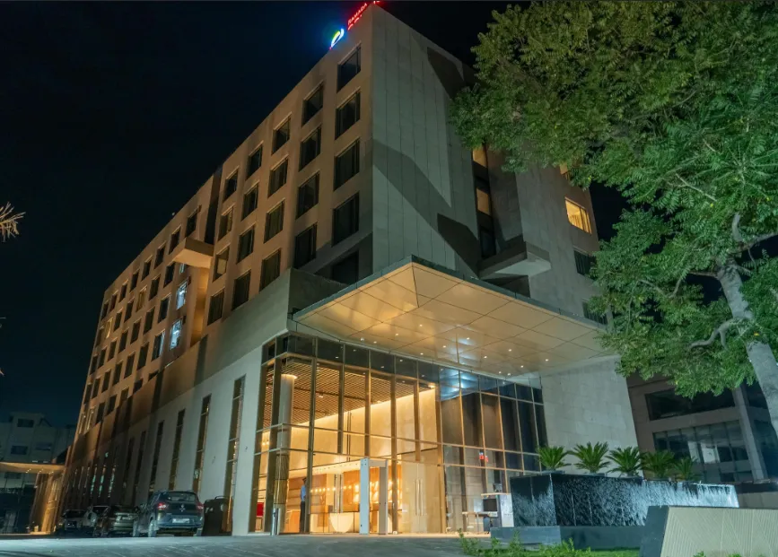Front entrance of Ramada Encore By Wyndham Bhiwadi showing hotel façade and driveway