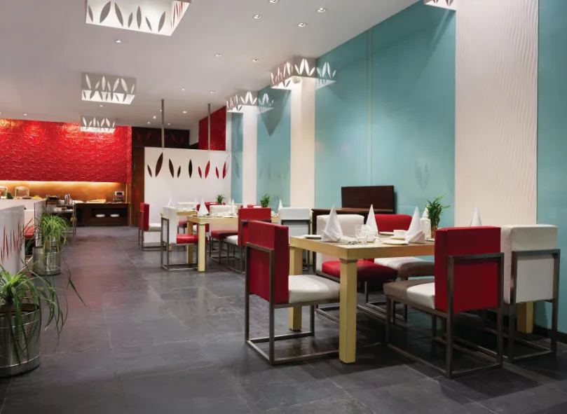 Restaurant at Ramada by Wyndham Ajmer with dining tables and interior design