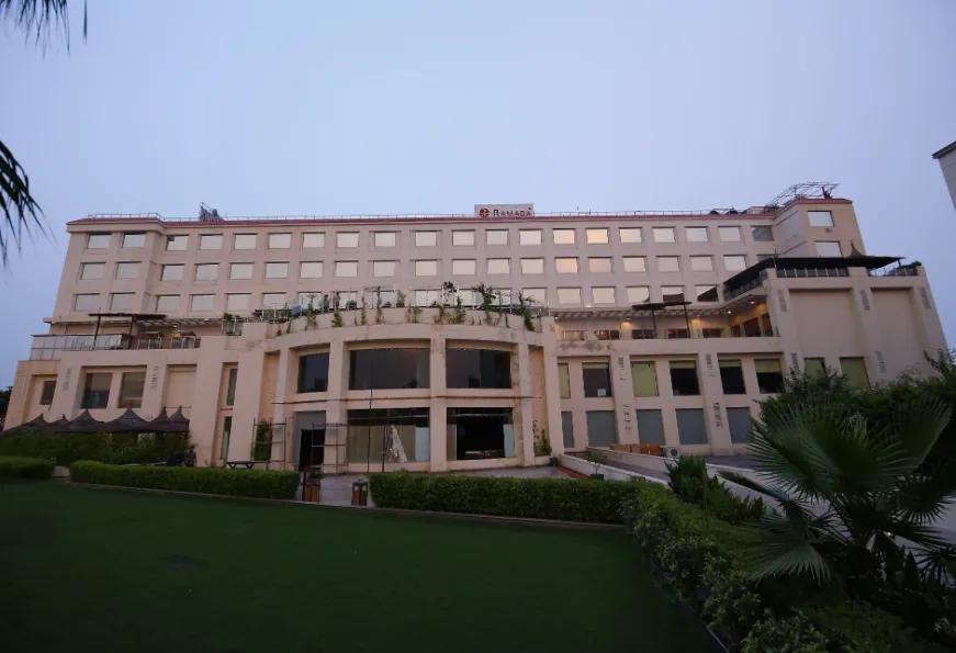 Entrance of Ramada by Wyndham Neemrana with building façade and signage