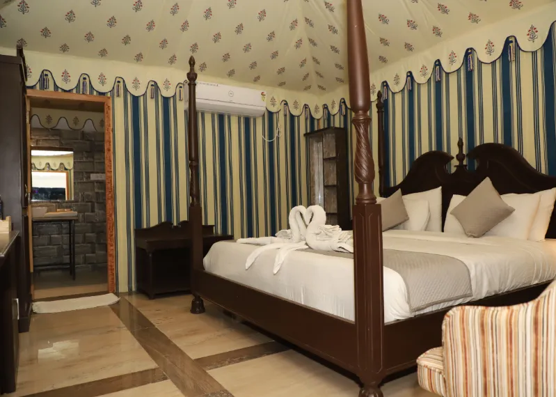 Deluxe tent at The Glorious Hills Resort Pushkar with bed and outdoor view